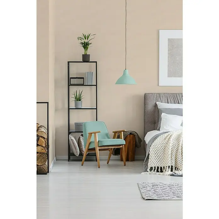 A.S. Création Trendwall 2 Vliestapete - Creme, Uni, 10,05 x 0,53 m - Modernes Interieur mit einem mintgrünen Sessel, einem Bücherregal mit Pflanzen und einem stilvollen Hängelampe, die eine entspannte Atmosphäre schafft.
