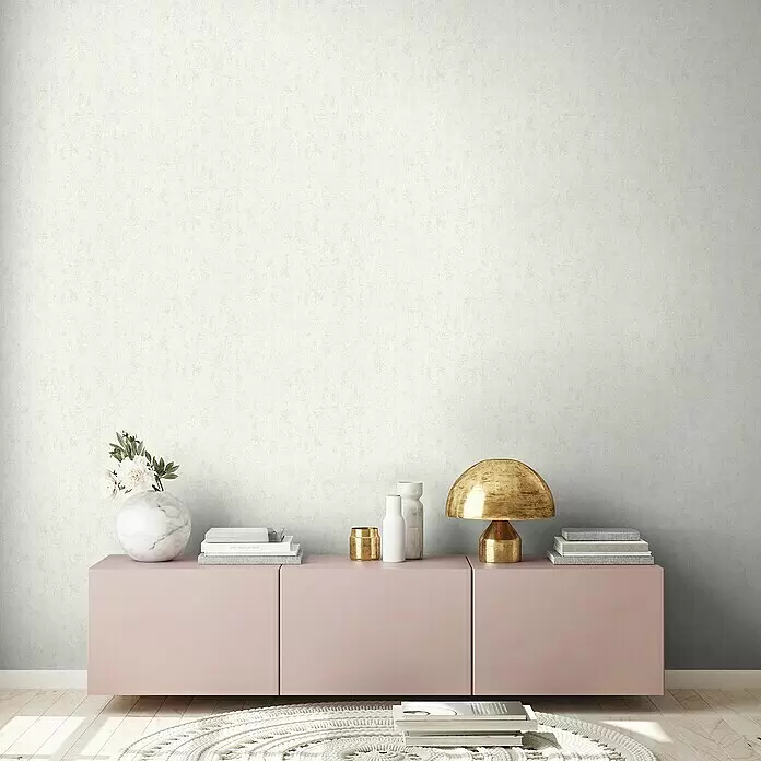 A.S. Création Hygge 2 Vliestapete - Creme, Uni, 10,05 x 0,53 m - Helle, strukturierte Tapete mit gesprenkeltem Muster in einem modernen Raum.