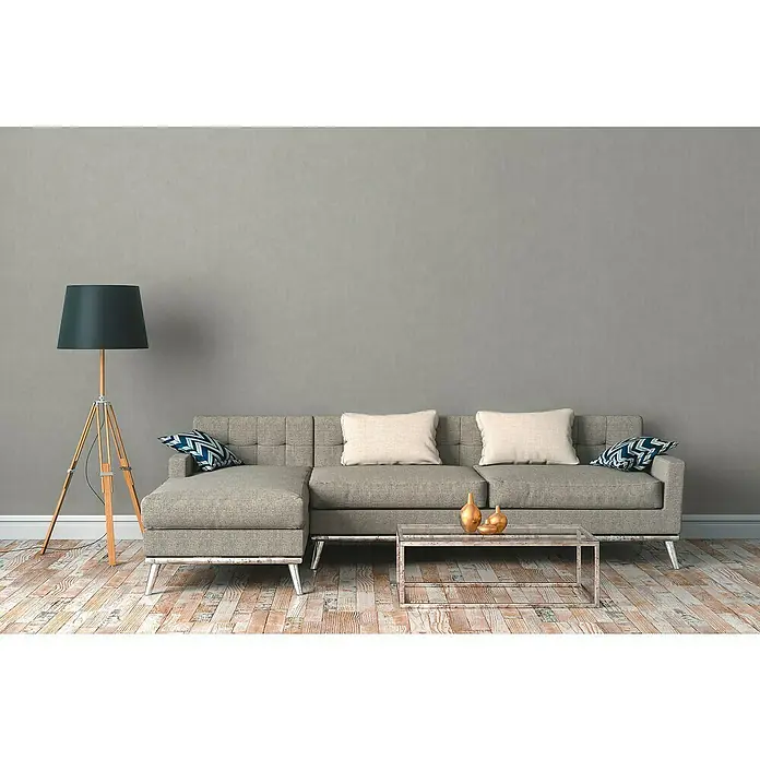 A.S. Création Cuba Vliestapete - Beige, Uni, 10,05 x 0,53 m - Wohnzimmer mit grauem Sofa, Stehlampe und Couchtisch. Das graue Sofa bietet Komfort und Stil in diesem gemütlichen Wohnbereich.