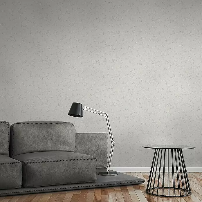 A.S. Création Attractive Vliestapete - Weiß/Grau, Uni, 10,05 x 0,53 m - Hellgraue strukturierte Wand, als moderne Kulisse in einem Wohnzimmer.