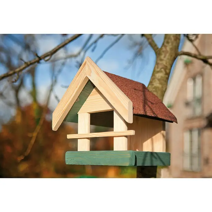 Kiehnholz Vogelhaus - 25 x 23 x 26 cm, Holz, Natur/Grün - Nahaufnahme eines dekorativen Vogelhauses aus Holz mit rotem Dach, das an einem Baum hängt. Ideal für Gartenliebhaber und Vogelfreunde.