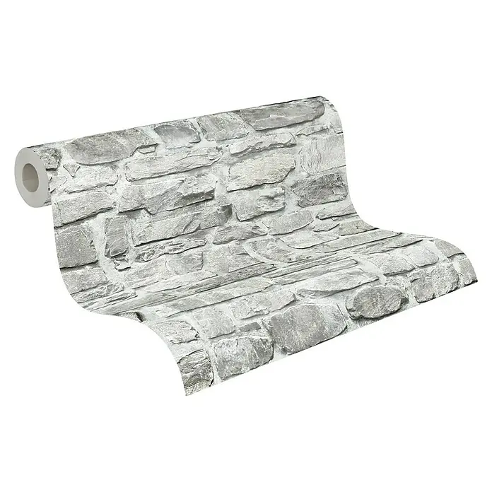 A.S. Création Il Decoro Vliestapete Bruchsteinmauer - Grau, Steinoptik, 10,05 x 0,53 m - Nahaufnahme einer Rolle grauer Steinmauer-Tapete, die die Textur und das Muster des Designs hervorhebt.