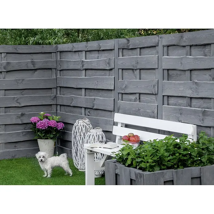 Sichtschutzelement Nevada - 89 x 179 cm, Grau - Im Vordergrund steht ein dekorativer grauer Holzzaun, der einen Garten mit Bank, Blumen und einem niedlichen kleinen weißen Hund schmückt.
