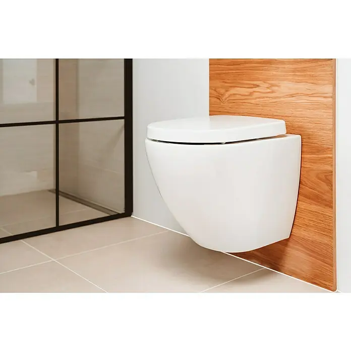 Camargue Wand-WC-Set Plus 50 2.0 - Spülrandlos, Ohne Spezialglasur, Spülform: Tief, WC Abgang: Waagerecht, Weiß - Wandhängende Toilette in einem Badezimmer mit Holzwandpaneel. Die Toilette ist weiß und hat einen geschlossenen Deckel.