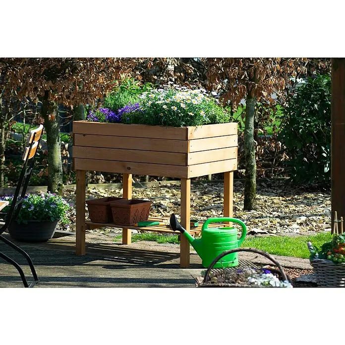 Dobar Hochbeet Kubus - 80 x 58 x 80 cm, Holz, Bernstein - Ein erhöhter, hölzerner Pflanzkasten voller Blumen im Garten mit einer grünen Gießkanne daneben. Praktisch für den Gartenfreund!