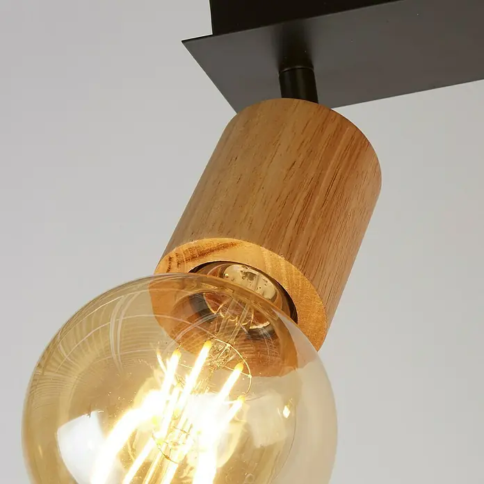 Searchlight Spinny Deckenstrahler - 120 W, L x B x H: 43 x 18 x 15 cm, Schwarz, E27, 2 Stk. - Nahaufnahme einer modernen Deckenleuchte mit Holzakzent und Edison-Glühbirne, die ein warmes Licht ausstrahlt.