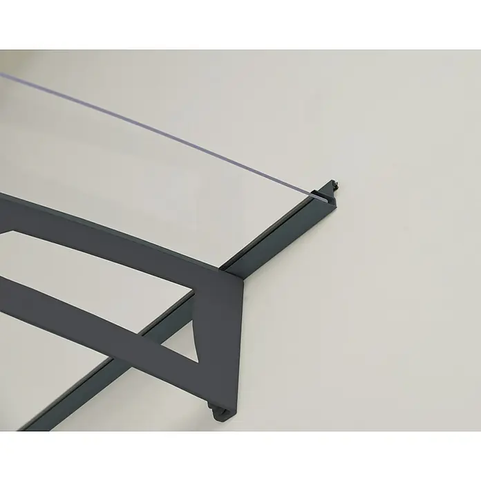 Palram – Canopia Pultvordach Aquila - 302 x 91,5 x 17,5 cm, Anthrazitgrau, Farbe Dach: Klar - Nahaufnahme einer modernen grauen Haustürvordach-Konstruktion mit klarem Glas, befestigt an einer weißen Wand.