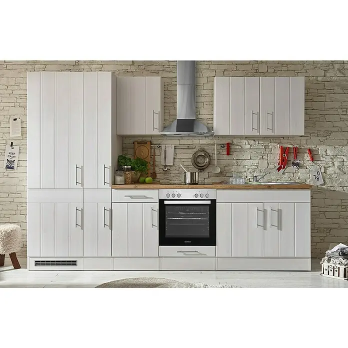 Respekta Premium Küchenleerblock Anton - Breite: 300 cm, Lärche Weiß Nachbildung, Ohne Elektrogeräte - Eine moderne weiße Küche mit Holzplatte, bestehend aus Schränken, Schubladen, Herd und Dunstabzugshaube vor einer Steinwand.
