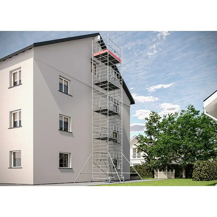 Krause ProTec XXL Rollgerüst Breitaufbau - Arbeitshöhe: 11,3 m, Belastbarkeit Plattform: 480 kg - Ein hohes, silbernes Rollgerüst steht an einer Hauswand, mit mehreren Ebenen und einer roten Plattform ganz oben, ideal für Bau- oder Renovierungsarbeiten.