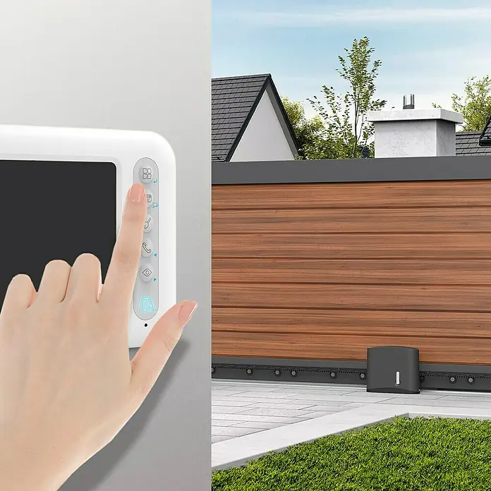 Avidsen Mecanismo de puerta de garaje Zenia 250 - Anchura puerta: 0 m - 4 m, 24 W - Imagen de un moderno sistema de intercomunicación con un dedo tocando un botón y una puerta automática al fondo.