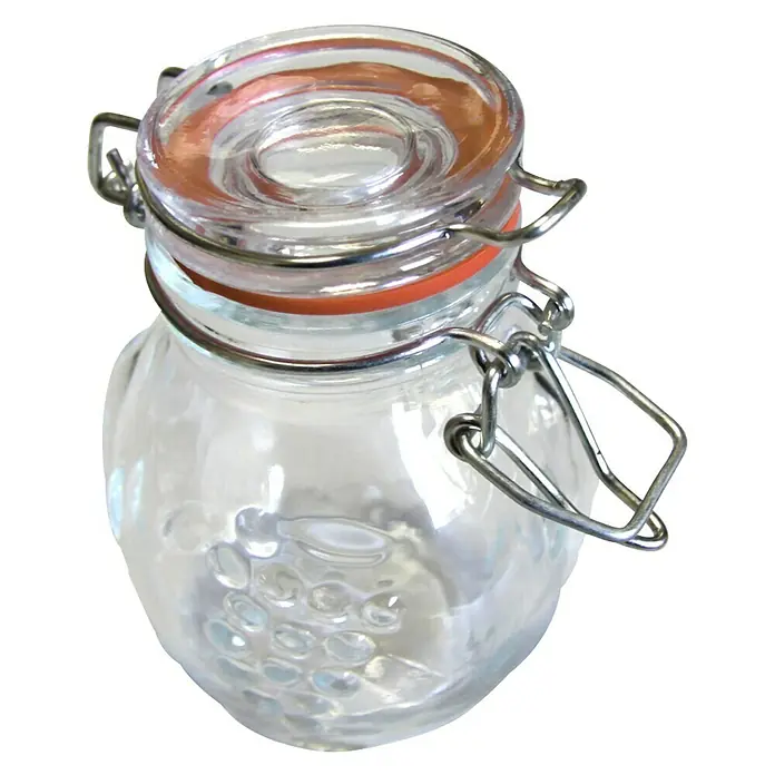 Frasco con cierre mecánico - Vidrio, Surtido - Tarro de cristal con cierre de alambre y diseño en relieve. El tarro está vacío, con una junta de goma naranja.