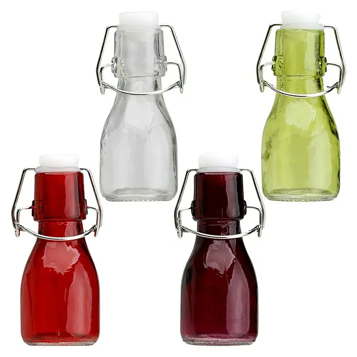Especiero con cierre mecánico - 1 ud., 75 ml, Vidrio - Botellas de vidrio de colores surtidos con cierres abatibles y tapas blancas, llenas de líquidos de colores sobre fondo negro.