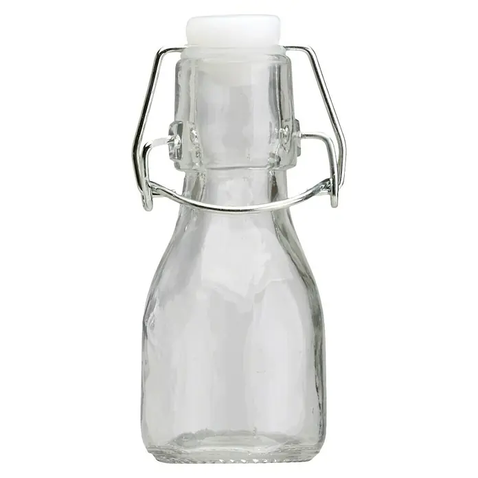 Especiero con cierre mecánico - 1 ud., 75 ml, Vidrio - Botella de vidrio transparente con cierre de ballesta y tapa blanca, ideal para almacenar líquidos y aceites. Práctica y decorativa.