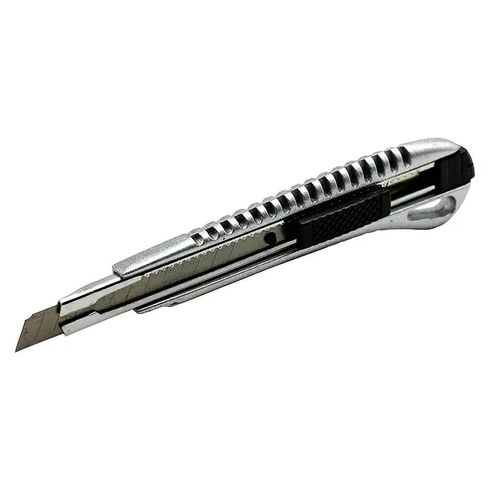 Cuchillo cúter metálico - Plateado/Negro - Primer plano de un cúter con la cuchilla extendida sobre un fondo negro.