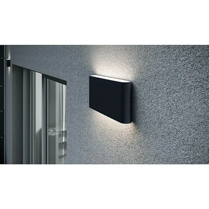 Trio Leuchten LED-Außenwandleuchte Thames II - 9 W, 9 x 17,5 x 3 cm, Anthrazit, IP54 - Moderne schwarze Wandleuchte an einer strukturierten grauen Wand, die ein warmes Licht nach oben und unten abstrahlt.