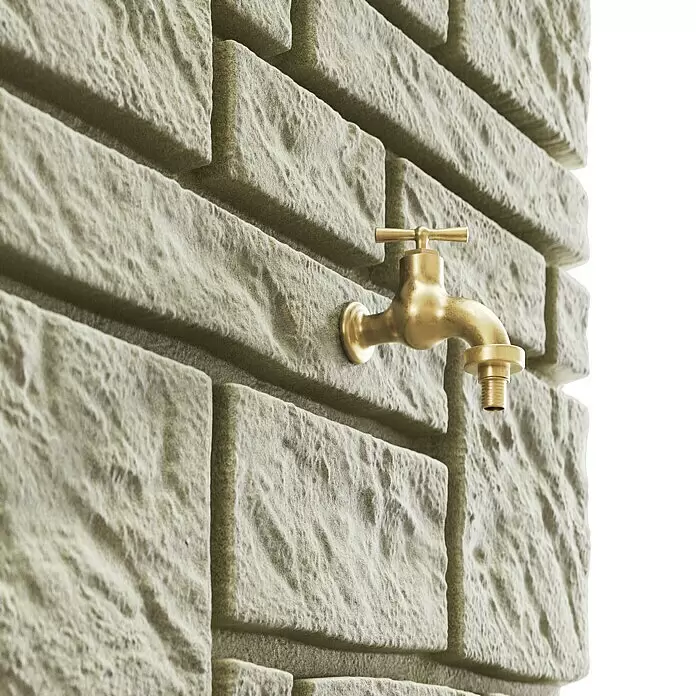 Arves Regenspeicher Maurano - 300 l, Sandsteinfarben, 1 Stk. - Goldener Messinghahn in klassischem Design, sicher montiert an einer rustikalen hellen Steinmauer.
