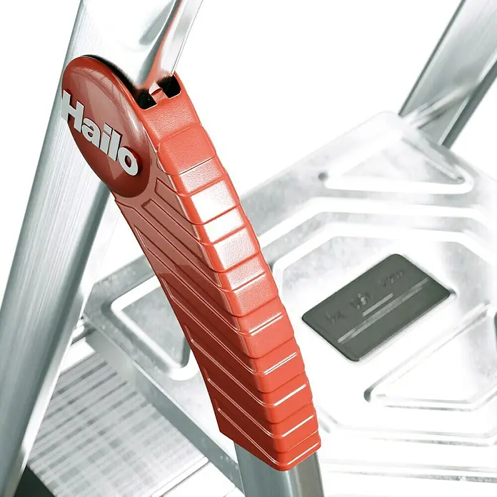Hailo Stehleiter XXL - Anzahl Tritte: 4 Stk., Arbeitshöhe: 2,6 m, Belastbarkeit: 150 kg, Aluminium - Nahaufnahme einer Hailo Trittleiter mit rotem Griff. Die robuste Konstruktion und das durchdachte Design bieten Sicherheit und Komfort.
