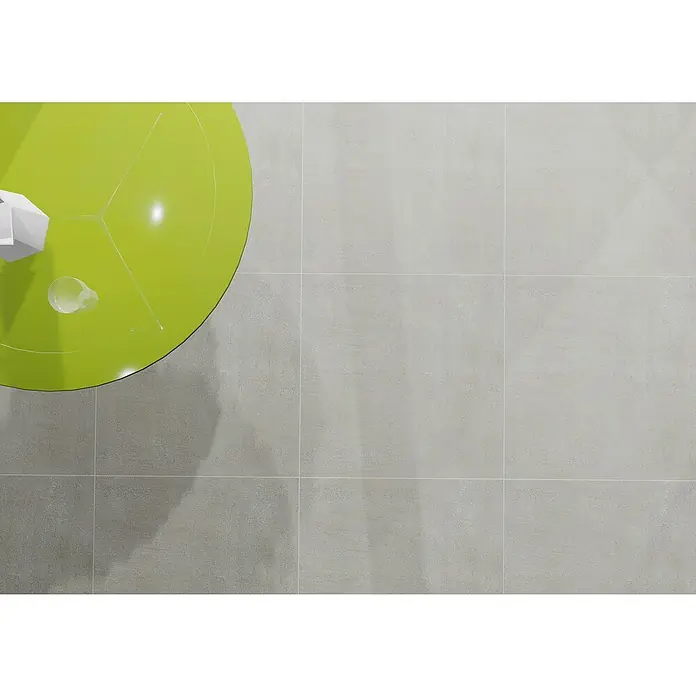 Marazzi Feinsteinzeugfliese Boston - 60 x 60 cm, Grau, Matt - Draufsicht auf einen grünen Tisch mit einem Getränk und einer weißen Dekoration, platziert auf grauen Fliesen.