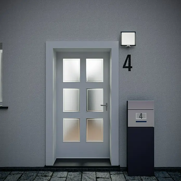 Steinel Sensor-Außenleuchte L 20 S anthrazit - 60 W, 8 x 24 x 23 cm, Anthrazit/Weiß, IP44 - Ein graues Haus mit einer Haustür mit Glaseinsätzen, einer Hausnummer und einem Briefkasten, alles in schlichtem Design.