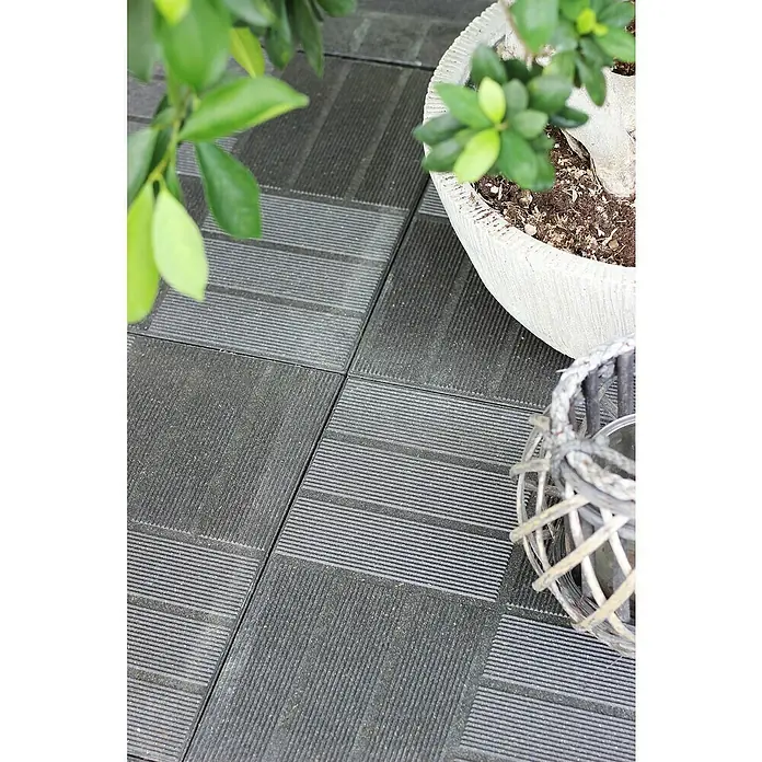 Klickfliese Mixtile - WPC, 40 x 40 x 4,5 cm, Anthrazit, 1 Stk. - Nahaufnahme von strukturierten, anthrazitfarbenen Terrassenfliesen, ergänzt durch einen Pflanztopf und eine dekorative Laterne.