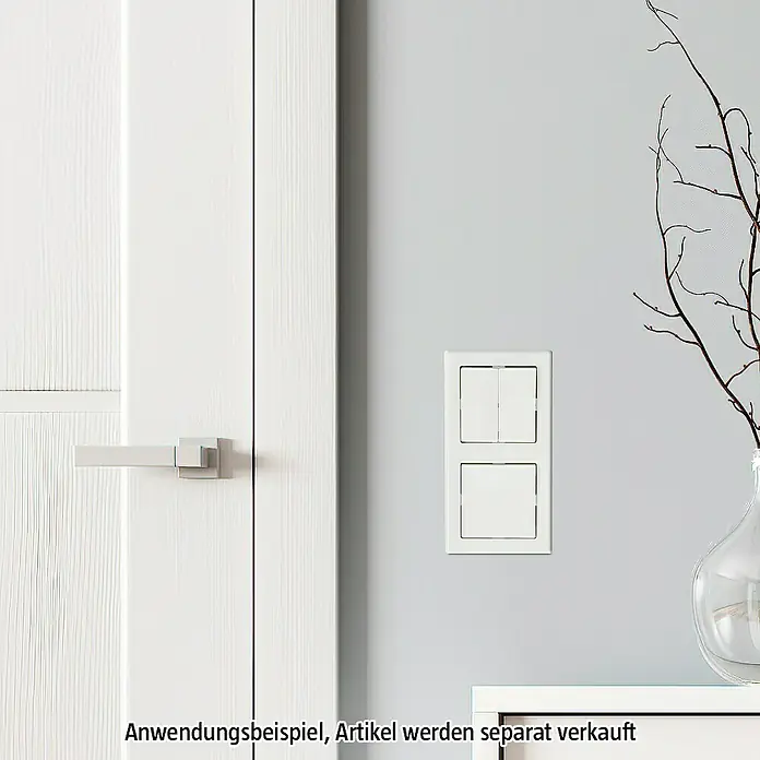Merten M-SMART Abdeckrahmen 478219 - Polarweiß glänzend, 2-fach, Kunststoff - Weiße Doppel-Lichtschalter mit rechteckigen Wippen und Rahmen, montiert an einer hellgrauen Wand neben einer weißen Tür und einer Vase.