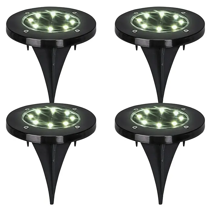 BAUHAUS Solarleuchten-Set Neue Generation - 0,1 W, Schwarz, IP44, 3 lm - Vier Solarleuchten für den Außenbereich mit Erdspieß in Schwarz, die auf einer dunklen Oberfläche angeordnet sind.