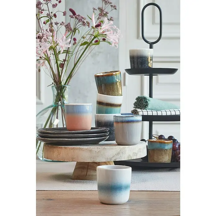Teller Tabo - 1 Stk., Ø x H: 20,5 x 2 cm, Keramik, Schwarz - Eine Nahaufnahme von gestapelten Tassen, Tellern und einem dekorativen Blumenarrangement auf einem Tisch.
