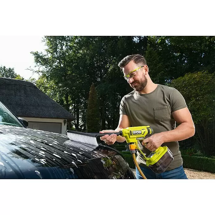 Ryobi Waschbürste - Rotierend - Mann wäscht ein schwarzes Auto mit Schaum mit einem gelben Ryobi EZCLEAN tragbaren Reiniger und Bürstenaufsatz.