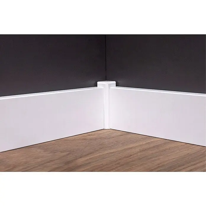 Sockelleiste - 240 x 1,6 x 5,8 cm, MDF, Foliert - Detailaufnahme einer weißen Sockelleiste mit Eckabdeckung, die einen sauberen Übergang zu einer dunklen Wand und einem hellen Holzboden bildet.