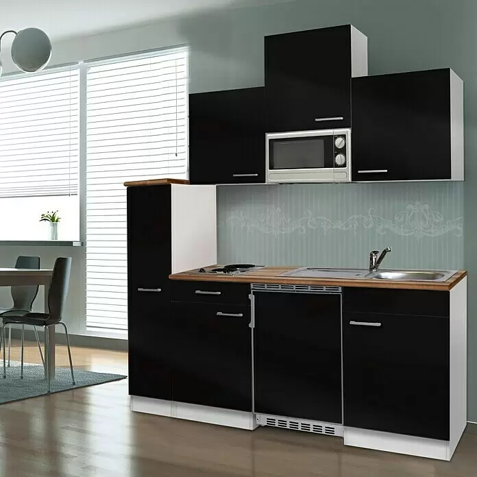 Respekta Cocina compacta Luis - Ancho: 180 cm, Negro, Color del cuerpo: Blanco, Con placa de cocina doble y microondas - Una moderna cocina compacta negra con encimera de madera, microondas, placa y fregadero integrados, en un ambiente de cocina luminoso.