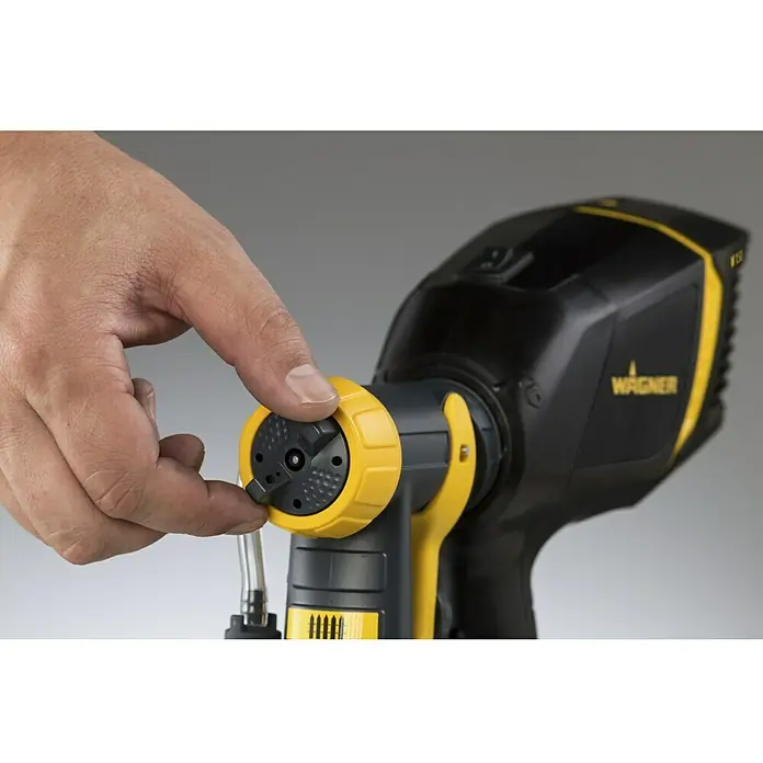Wagner Farbsprühsystem W 150 Wood & Metal - 300 W, Förderleistung: 0,14 l/min - Wagner Farbsprühgerät im Detail: Eine Hand passt die Düse an, um präzise Sprühaufträge zu ermöglichen. Perfekt für Projekte aller Art.