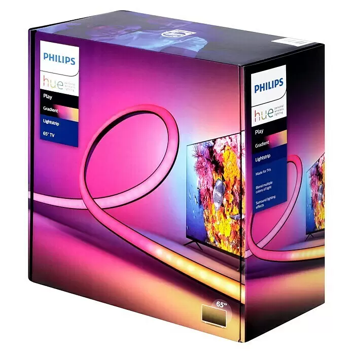 Philips Hue LED-Stripes Play Gradient 65 Zoll - Länge: 254 cm, Mehrfarbig - Philips Hue Play Gradient Lightstrip 65" TV Box, zeigt den Lichtstreifen, der eine Wand hinter einem Fernseher farbig beleuchtet.