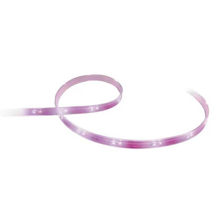 Philips Hue LED-Band Plus Basis - 2 m, RGBW - Nahaufnahme eines Philips Hue Lightstrip, der sanft in Rosa und Lila leuchtet und sich elegant vor einem schwarzen Hintergrund windet.