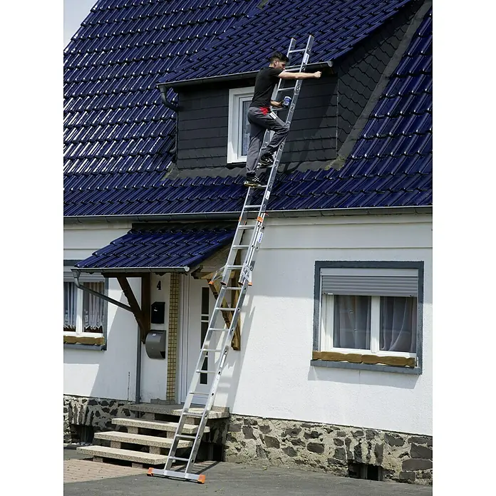 Krause Monto Schiebeleiter Fabilo - Anzahl Tritte: 24 Stk., Arbeitshöhe: 6,85 m, Aluminium - Ein Handwerker steigt auf einer KRAUSE Leiter an einer Hausfassade empor, um Reparaturen auszuführen. Die Leiter steht stabil und sicher.