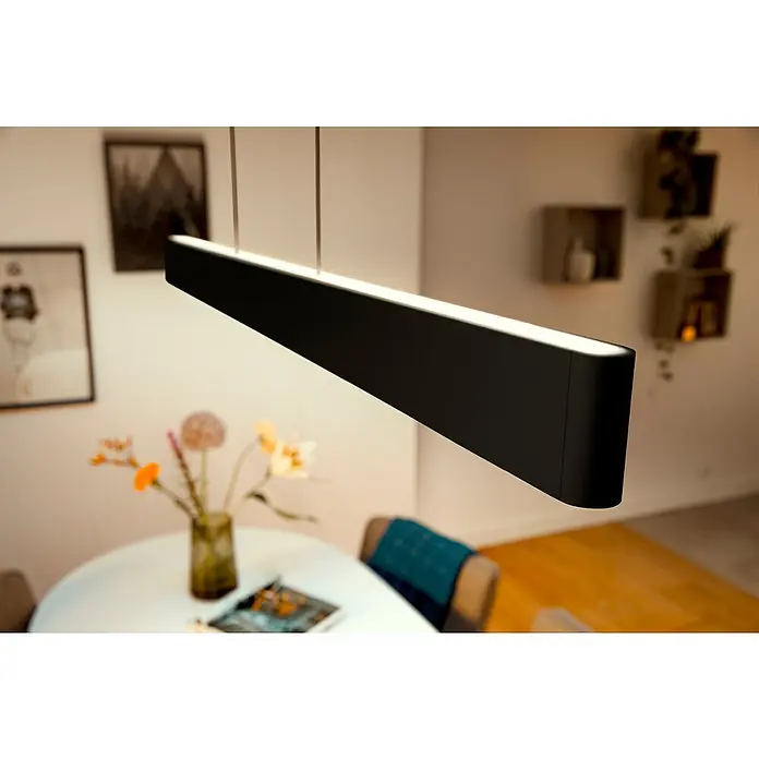 Philips Hue LED-Pendelleuchte White and Color Ambience Ensis - 79 W, L x B x H: 129,9 x 4 x 157 cm, Schwarz, RGBW - Moderne LED-Pendelleuchte in Schwarz über einem Esstisch, die ein stilvolles Ambiente schafft.
