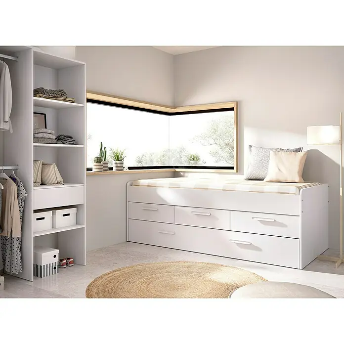 Dekit Cama nido Leka - L x An x Al: 195 x 95 x 68 cm, Blanco - Una habitación infantil luminosa con una cama blanca con cajones, un armario y una alfombra redonda. La cama ofrece soluciones de almacenamiento prácticas.