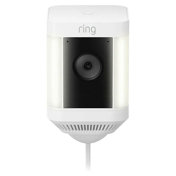 Ring Überwachungskamera Spotlight Cam Plus Plugin - Netzbetrieben, 1.080 Pixel (Full HD), Weiß, B x H: 7,6 x 12,6 cm, Netzanschluss - Nahaufnahme einer weißen Ring Sicherheitskamera mit Lichtern an den Seiten und einer schwarzen Kameralinse in der Mitte.