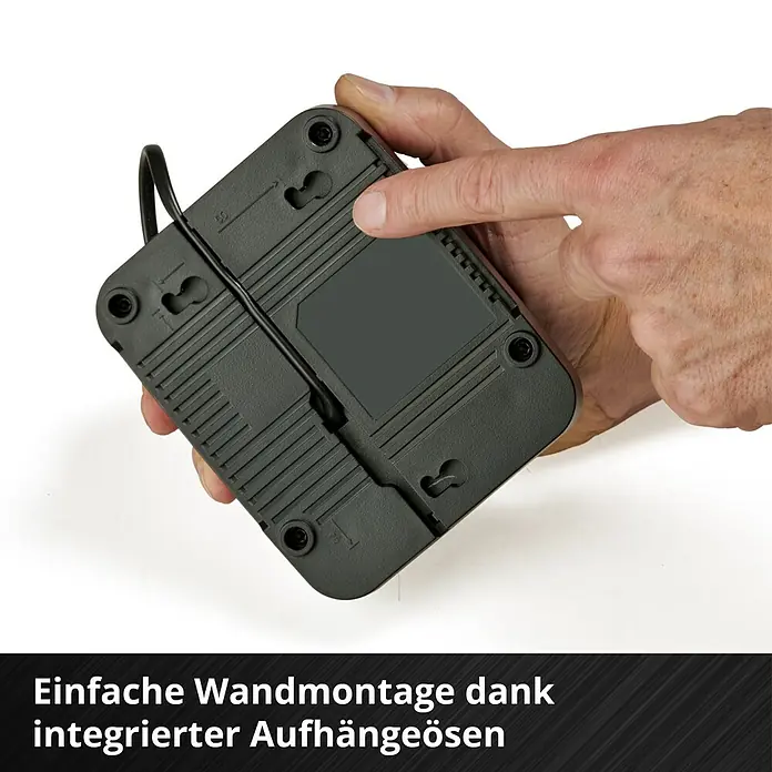 Einhell Power X-Change 18V Akku & Ladegerät PXC-Starter-Kit - 18 V, 1 Akku, 4 Ah - Produktansicht: Schwarzes Gerät mit integrierten Aufhängeösen für einfache Wandmontage.