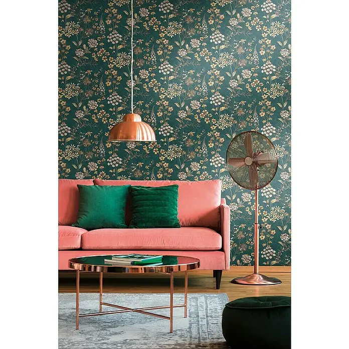 A.S. Création Metropolitan Stories Travel Styles Vliestapete Blumen II - Blau/Gelb, Floral, 10,05 x 0,53 m - Das Wohnzimmer verfügt über ein korallfarbenes Sofa mit grünen Kissen, einen Kupfer-Couchtisch und eine passende Lampe.