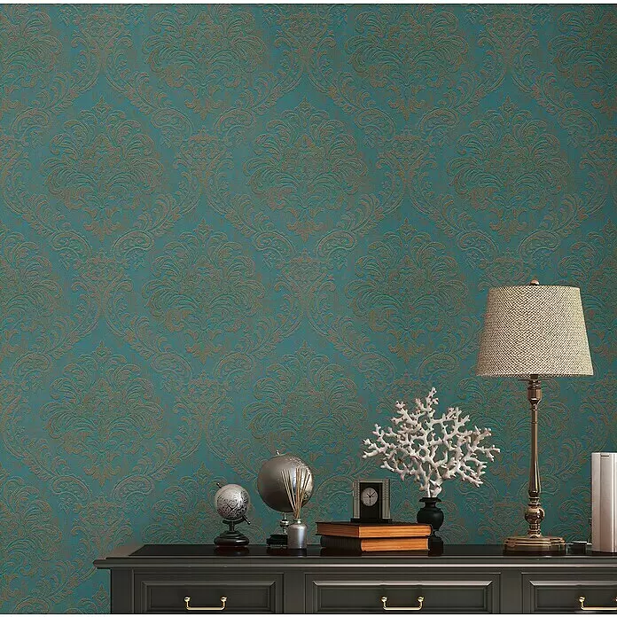 A.S. Création Metropolitan Stories Travel Styles Vliestapete Damask - Blau/Gold, Ornament, 10,05 x 0,53 m - Elegante türkise Tapete mit geprägtem Gold-Damastmuster, als stilvolle Wandverkleidung präsentiert.