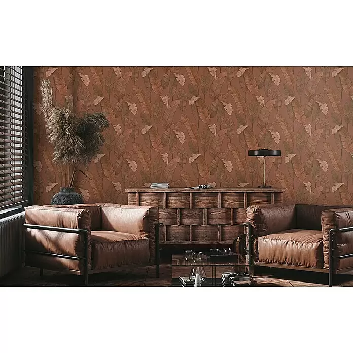 A.S. Création Metropolitan Stories Travel Styles Vliestapete - Rost, Floral, 10,05 x 0,53 m - Rotbraune Tapete mit braun-grünem Blattmuster an der Wand eines gemütlichen Wohnzimmers.