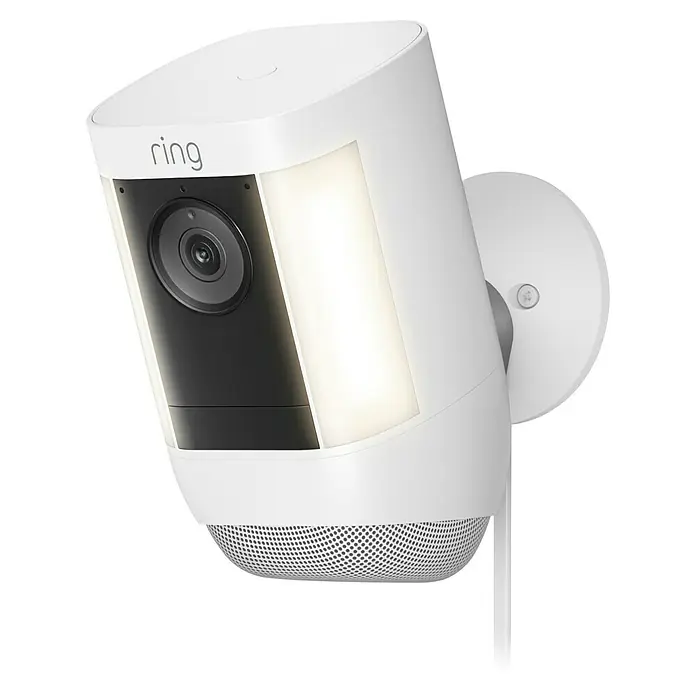 Ring Überwachungskamera Spotlight Cam Pro Plugin - Weiß, Auflösung: 1.080 Pixel (Full HD), Netzanschluss - Nahaufnahme einer weißen Ring Sicherheitskamera mit Flutlicht für den Außenbereich, die auf einer schwarzen Oberfläche steht.
