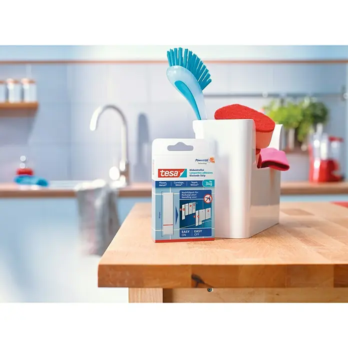 Tesa Powerstrips Tira autoadhesiva - 6 ud., Carga soportada: 3 kg - Detalle de los adhesivos Tesa Powerstrips, ideales para colgar y quitar objetos de hasta 3 kg en superficies lisas fácilmente.