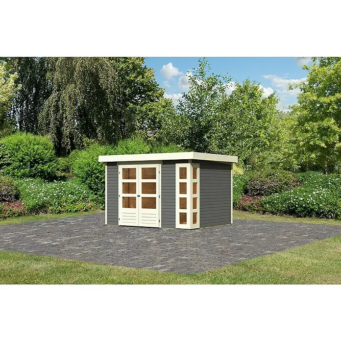 Karibu Gartenhaus Kerko 5 - Außenmaß inkl. Dachüberstand (B x T): 329 x 262 cm, Holz, Terragrau - Eine moderne Gartenhütte mit Doppeltür und seitlichem Fenster steht auf einem gepflasterten Bereich, umgeben von Grün.