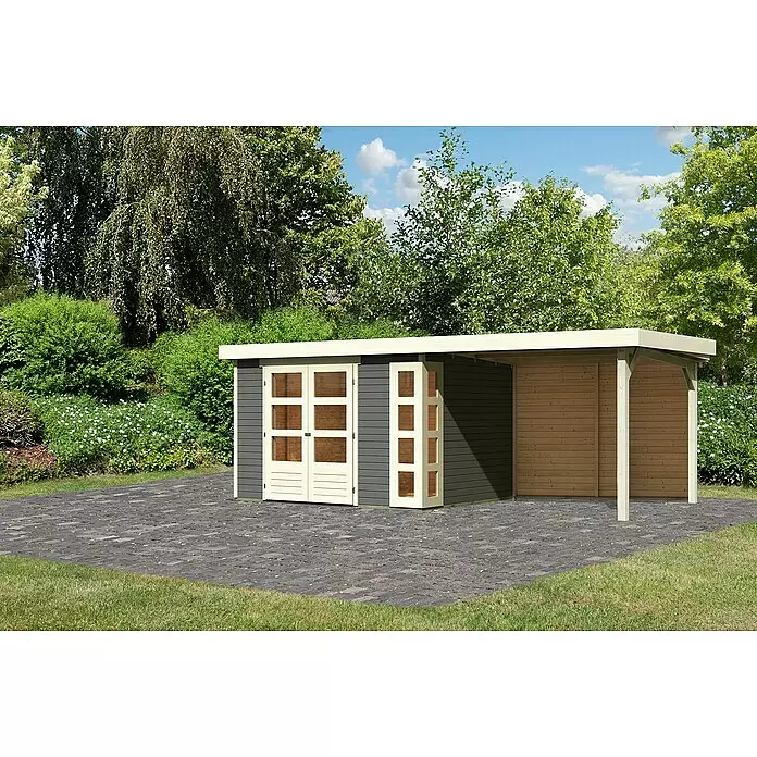 Karibu Gartenhaus Kerko 5 - Außenmaß inkl. Dachüberstand (B x T): 591,5 x 262 cm, Holz, Terragrau, Mit Seitendach und Rückwand - Moderner dunkelgrauer Gartenhaus mit cremefarbenen Türen und integriertem Carport auf einem gepflasterten Bereich im Garten.