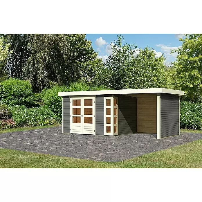 Karibu Gartenhaus Kerko 5 - Außenmaß inkl. Dachüberstand (B x T): 554 x 262 cm, Holz, Terragrau, Mit Seitendach, Rück- und Seitenwand - Moderner, dunkelgrauer Holzgeräteschuppen mit hellen Türen, Fenstern und offenem Carport auf gepflasterter Terrasse im Garten.
