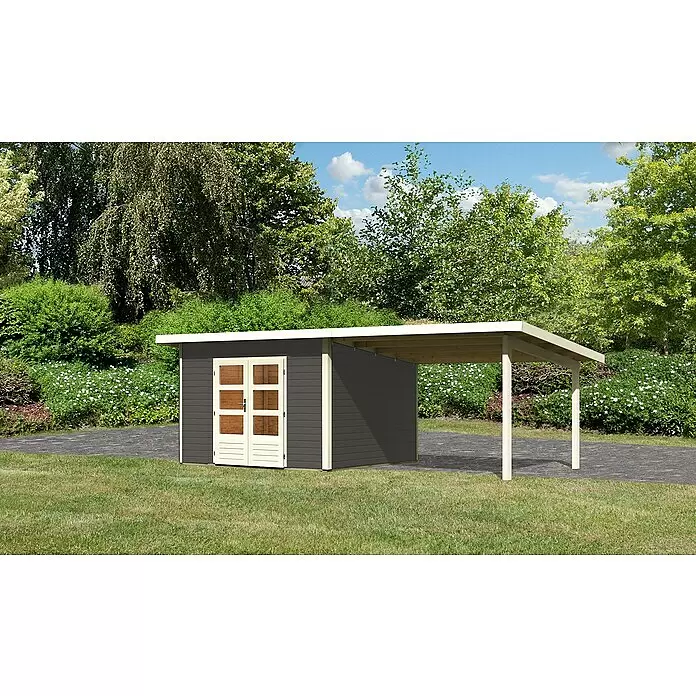 Karibu Gartenhaus Northeim 3 - Außenmaß inkl. Dachüberstand (B x T): 664 x 331,5 cm, Holz, Terragrau, Mit Seitendach - Dunkelgrauer Geräteschuppen mit hellem Rahmen und Doppeltür, inklusive integriertem Carport, auf Rasen neben gepflastertem Weg.