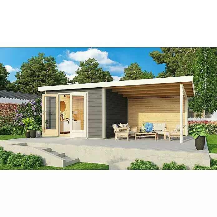 Karibu Gartenhaus Radeburg 1 - Außenmaß inkl. Dachüberstand (B x T): 664 x 331,5 cm, Holz, Terragrau, Mit Seitendach und Rückwand - Modernes dunkelgraues Gartenhaus mit überdachter Holzterrasse und hellgrauem Deck, in einem grünen Garten.