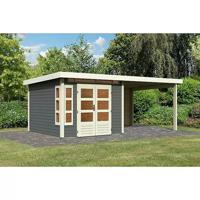Karibu Gartenhaus Kastorf 6 - Außenmaß inkl. Dachüberstand (B x T): 612 x 303 cm, Holz, Terragrau, Mit Seitendach und Rückwand - Dunkelgraues Gartenhaus aus Holz mit hellem Holzrahmen und angebautem Carport, auf Pflastersteinen im Garten.