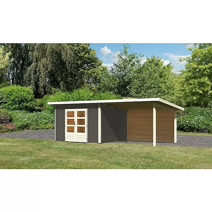 Karibu Gartenhaus Northeim 3 - Außenmaß inkl. Dachüberstand (B x T): 664 x 331,5 cm, Holz, Terragrau, Mit Seitendach und Rückwand - Dunkelgrauer Gartenschuppen mit hellen Türen und Verkleidung, angebauter Carport aus Naturholz mit hellen Pfosten, auf Rasen mit Pflasterweg.